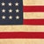 This vintage American flag is made from a cotton cloth with fully sewn stars and stripes. Please note overall staining and...