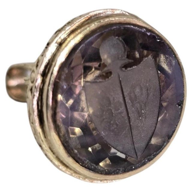 A distinctive vintage 9ct yellow gold novelty charm, fob or seal dating to 1967, combining traditional heraldic...