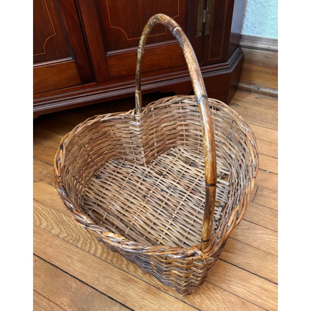 Large and beautiful antique split-bamboo wicker basket formed in the shape of a heart. Bamboo has a burnt or darken...