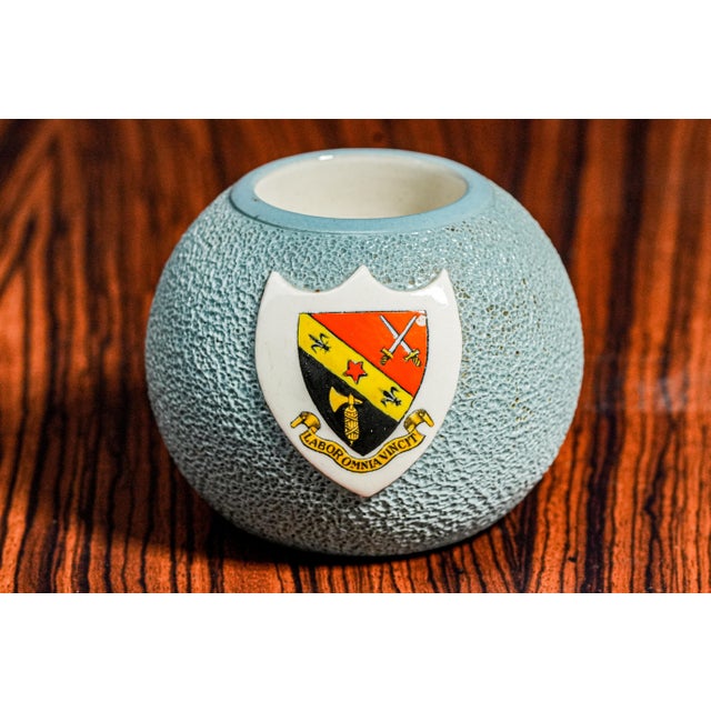 A striking piece of Edwardian-era craftsmanship, this circa 1910 porcelain match holder striker features a charming...