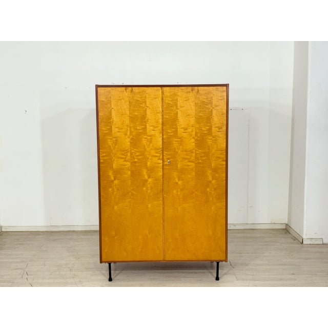 For sale is a beautiful wardrobe from the 1960s. The wardrobe impresses with its simple design, warm birchwood finish, and...