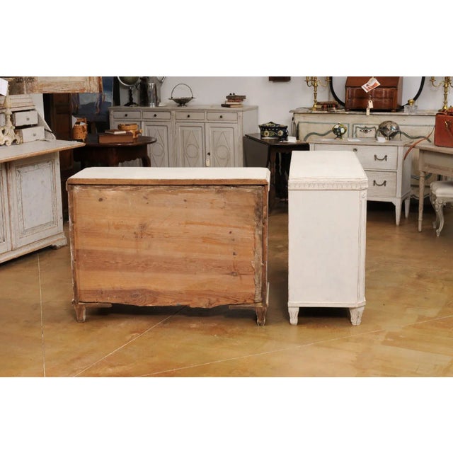 A pair of Swedish Gustavian style painted wood chests circa 1850 with carved frieze, three drawers, fluted and canted side...