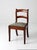 Early 20th century French country ladder-back chair with a needlepoint seat in a muted floral motif on a soft ground....