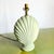 A charming nod to coastal nostalgia, this postmodern table lamp features a sculptural clam shell silhouette in a soothing...