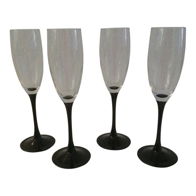 Lovely set of eight crystal black long-stemmed champagne flutes. Each glass holds 4 oz. Excellent condition.