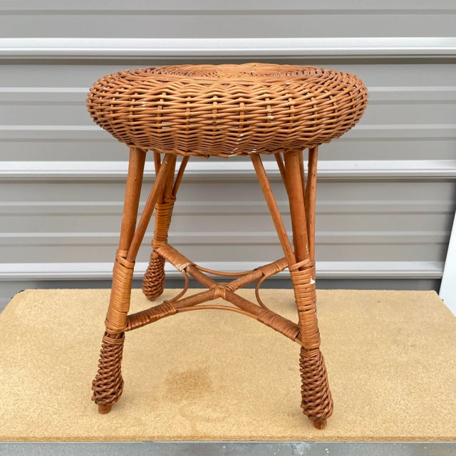 Step back into the stylish 1970s with this charming wicker stool. This vintage piece emanates a warm, timeless appeal,...