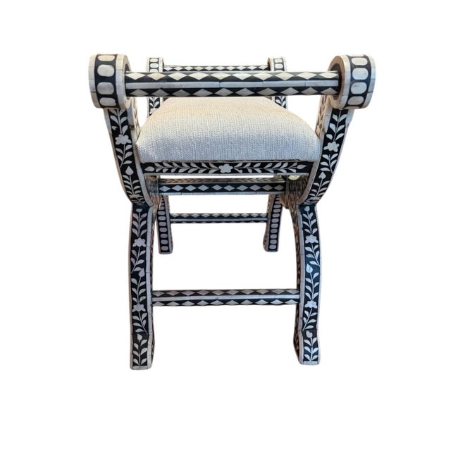 Terrific black and white bench seat of inlaid bone by Arhaus. This inlaid bone, curule leg stool is patterned with...