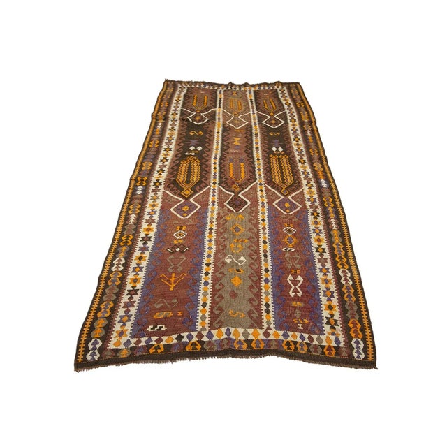 Decorative Vintage handwoven kilim rug from Kars region of Turkey. Approximately 50-60 years old. In very good condition.