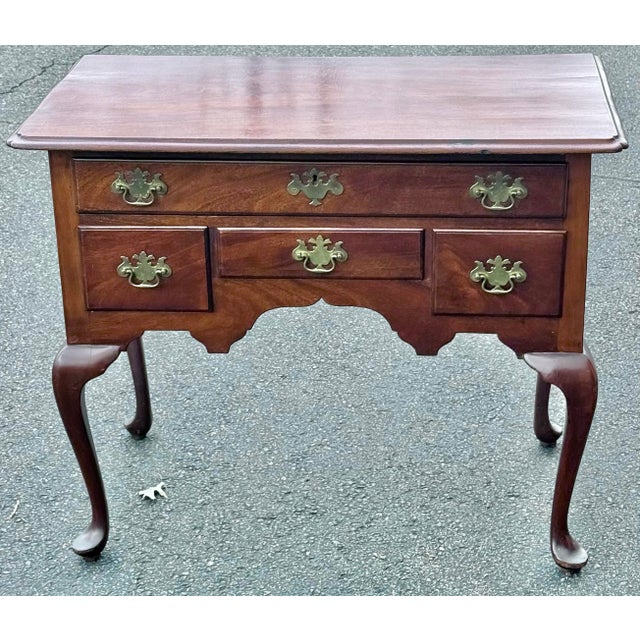 Antique 18th century Queen Anne mahogany lowboy (or dressing table) featuring classic cabriole legs with pad feet and an...