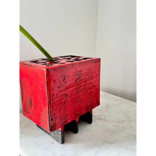Unique handmade ceramic vase from the 1970s, glazed in rich red tones. Asian-inspired design with an intricate top full of...