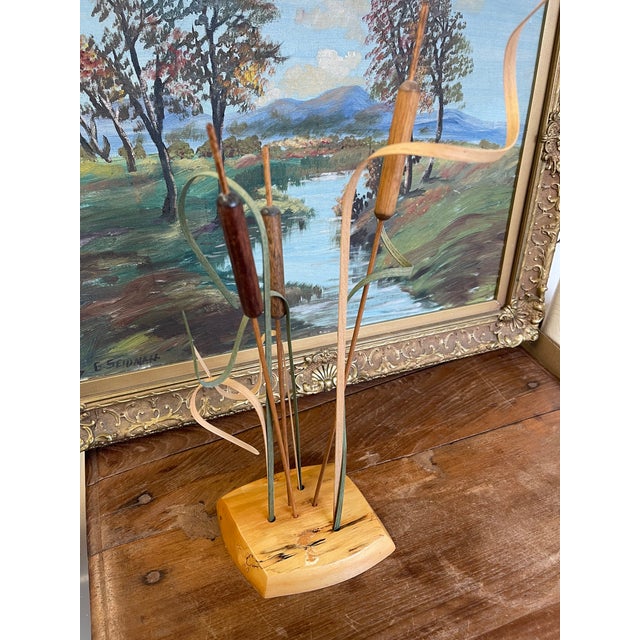 Handcrafted wooden cattail sculpture by Wood N' Things, labeled "Handmade in Minnesota." This studio craft piece features...