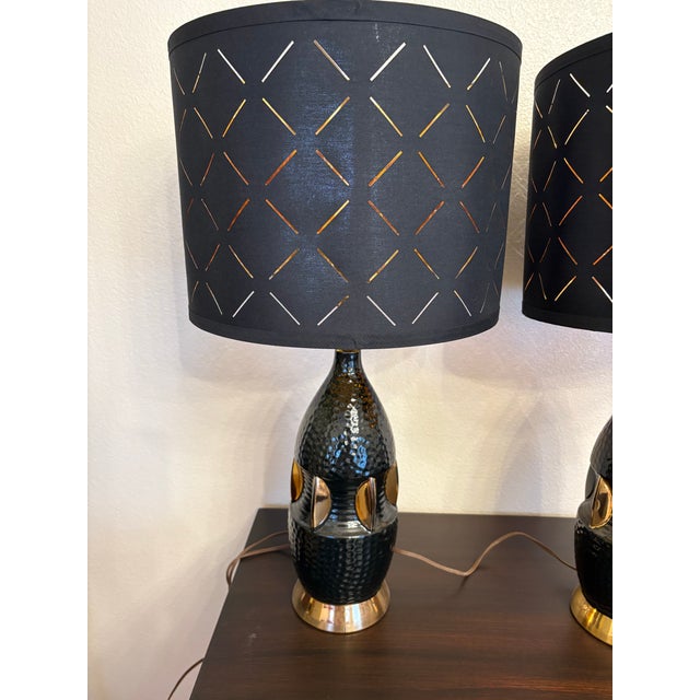 This pair of Atomic gold and black ceramic lamps are striking by themselves but the shades are another level entirely. The...