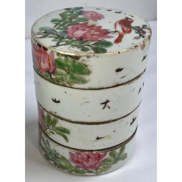This charming ceramic box is painted with chrysanthemums and leaves on each tier and a bird on the top. There is also some...