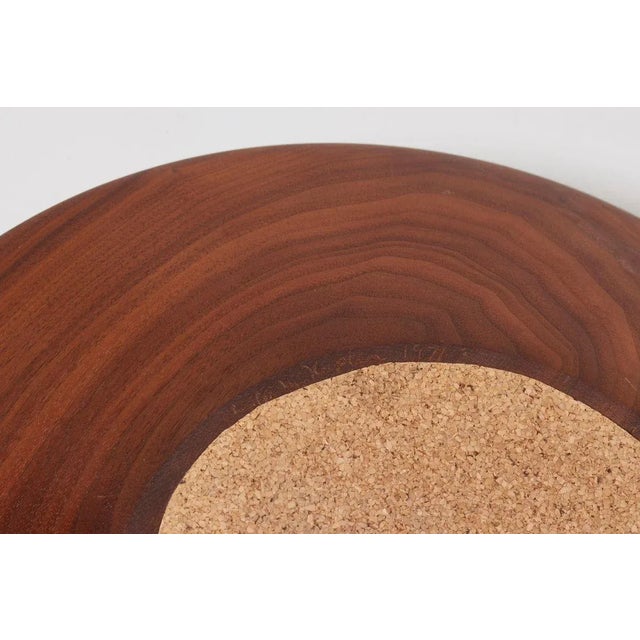 Laminated walnut bowl by Charles M. Kaplan. This piece is attributed to the mentioned designer/maker. It has no...