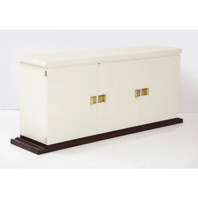 A beautiful original Tommi Parzinger 1960s ivory and mahogany cabinet restored.