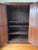 Large mid 20th century European style rustic two-door armoire adorned with an ornate haveli style brass overlay. Solid...