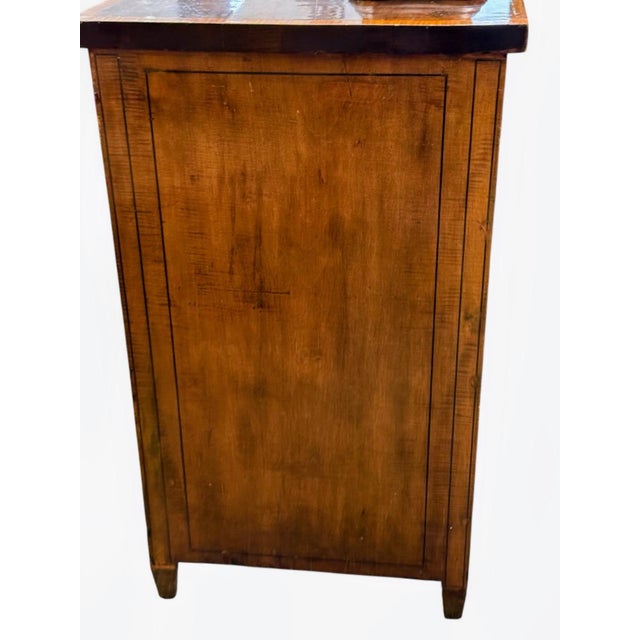 Elegant antique sideboard. Has beautiful wood with intricate satinwood inlays. Curved bow-front design. Floral inlay on...