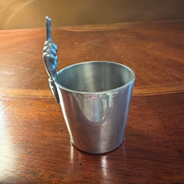 The Antique Abercrombie & Fitch Co. by James Dixon & Sons "One Finger" Jigger / Shot is a collectible barware item made of...