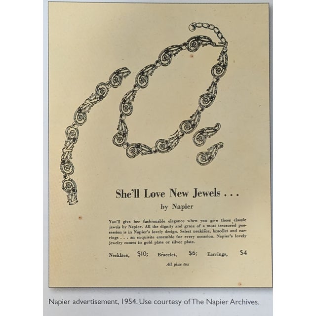 1954 silvertone floral openwork climber clip earrings. Marked "NAPIER PAT. PEND." on the clips. Measure: 1 1/2 inches long...