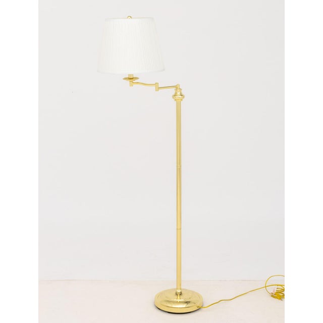 Pair of Modern Polished Brass Adjustable Floor Lamps, each with articulated arm and white pleated shade. Most compact...