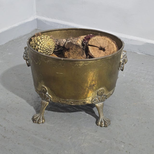 Good oval brass rivetted log bin, standing on bird feet with lion ring handles. 12" high 16" wide 14" depth