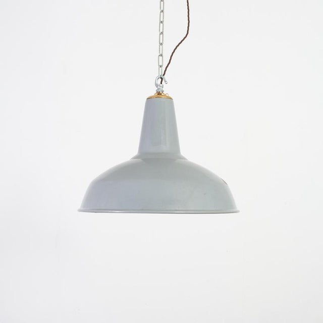 A large iconic industrial factory light shade manufactured by benjamin crysteel. The light shade is a spun vitreous glass...
