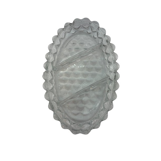 This relish dish, manufactured by Fostoria, is divided into three sections. It features the American pattern, which...