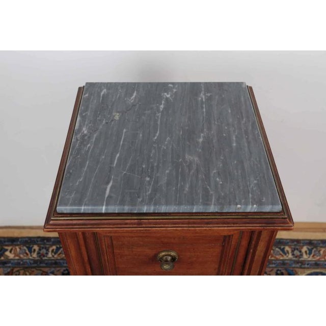 Antique Louis XVI style bedside table with a grey marble top, the top has a faceted edge. The table is made of solid...