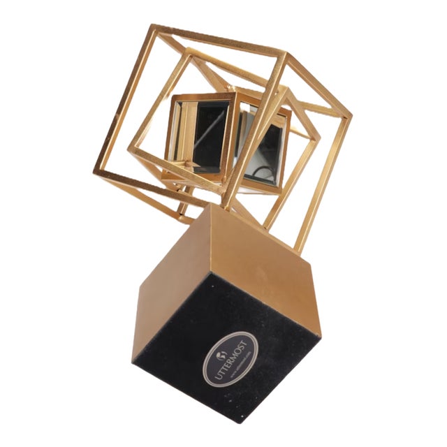 With its geometric shapes combined with lightly antiqued metallic gold and rotating mirrors, this unique sculpture from...