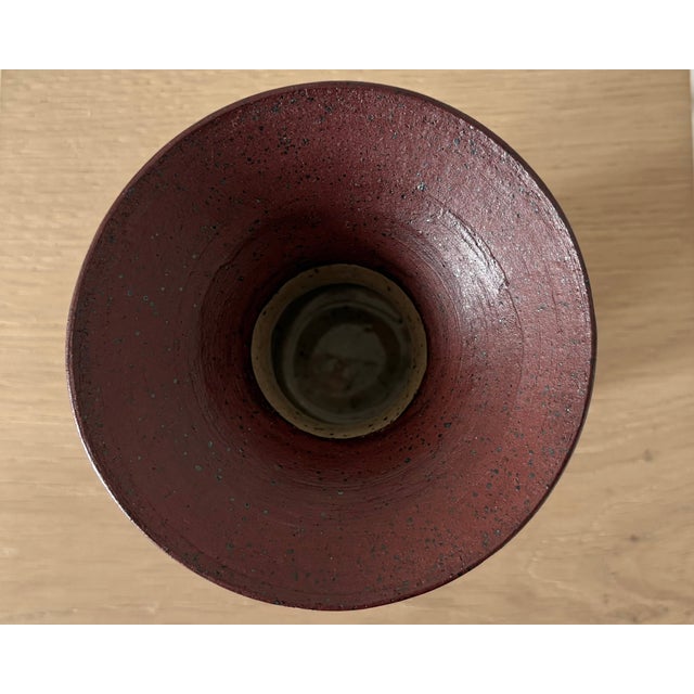 A sculptural American studio pottery pedestal vessel made in New York, combining a creamy speckled cylindrical base with a...