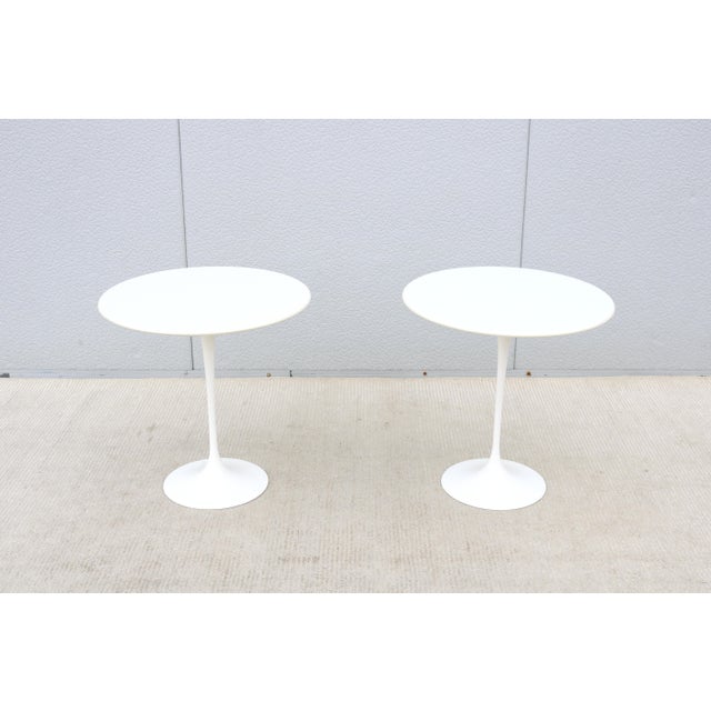 Fabulous pair of 20" round white laminate top tulip side tables designed by Eero Saarinen for Knoll. The Saarinen tulip...
