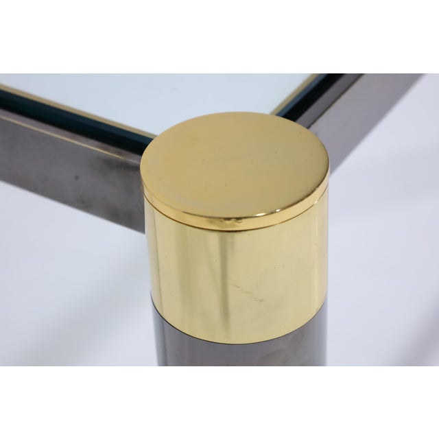 Karl Springer is renowned for his finishes and elegant designs. This table is gunmetal and brass with a glass top. Incised...