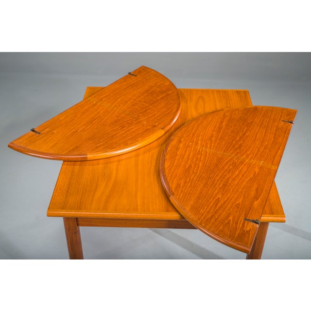 Bring timeless Scandinavian elegance into your home with this exquisite 1960s extendable teak dining table, likely...