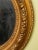 Beautiful pair of antique gilded wood and gesso oval mirrors. The gilding retains a warm, aged patina with light wear,...