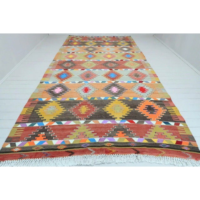 This beautiful, traditional vintage, flat weaved Turkish kilim rug is approximately 60 years old. It is handmade of very...