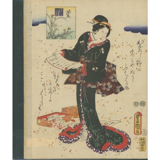 Original Japanese ukiyo-e color woodblock print (nishiki-e) depicting a fashionable woman reading a letter, with a...