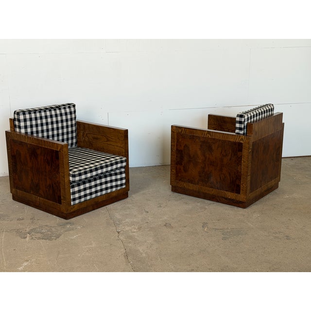 European Art Deco club armchairs in burl walnut and veneered wood, 1930s, sold as a pair. Each chair is built in a strict...