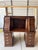 Beautiful vintage roll-top desk featuring a classic curved tambour front, paneled sides, and a rich dark oak brown wood...