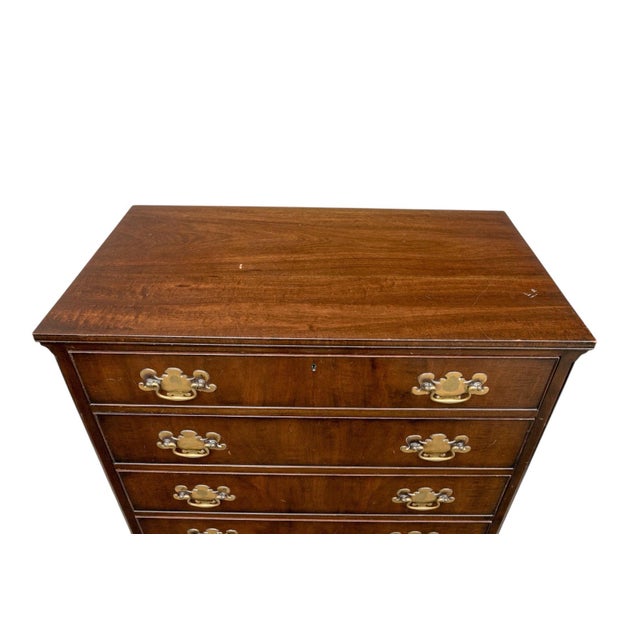 Impressive Pair of Kittinger George III Style Mahogany Four Drawer Bachelors Chests With Brass Hardware This exquisite...