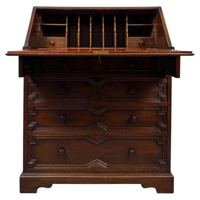 A handsome and beautifully proportioned 20th-century Jacobean style oak bureau, combining traditional craftsmanship,...
