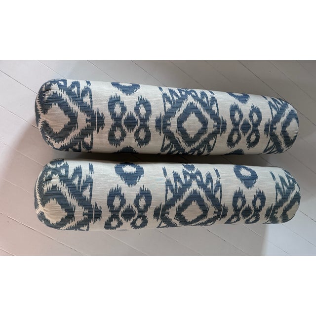 A matching pair of cotton blue and white Ikat bolster pillows with no visible marks or stains in good condition used with...