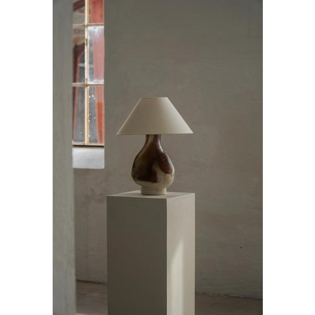 A sculptural and expressive table lamp in glazed stoneware, model 989, produced in denmark during the 1960s–1970s by...