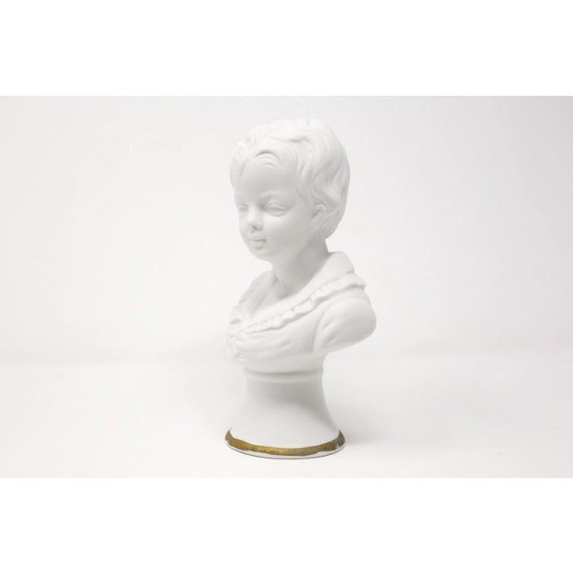 A vintage, porcelain bust of a boy, with gold trim. Good vintage condition.