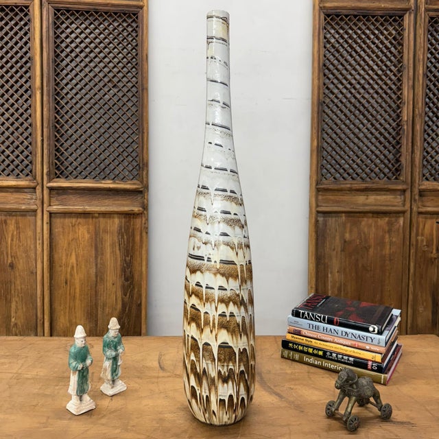"About This Piece About This Piece This vase is tall, sleek, and full of character, the kind of piece that instantly makes...