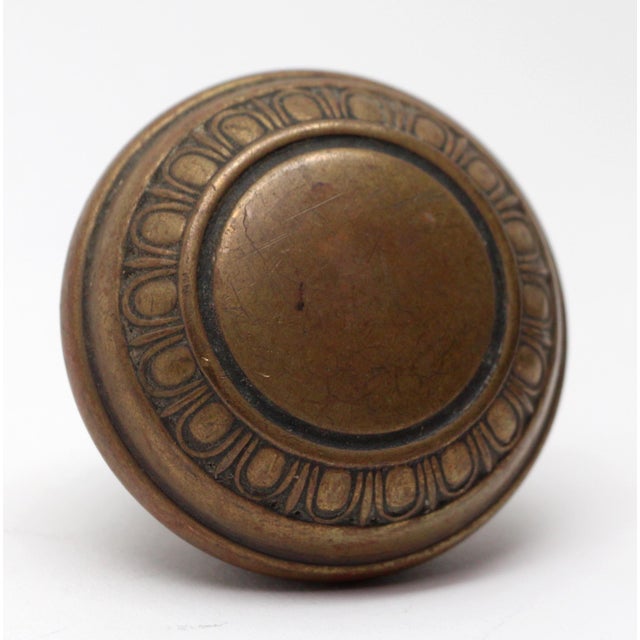 Brass door knob with a concentric egg & dart design. It is part of the M-15500 group. The manufacturer and exact date of...