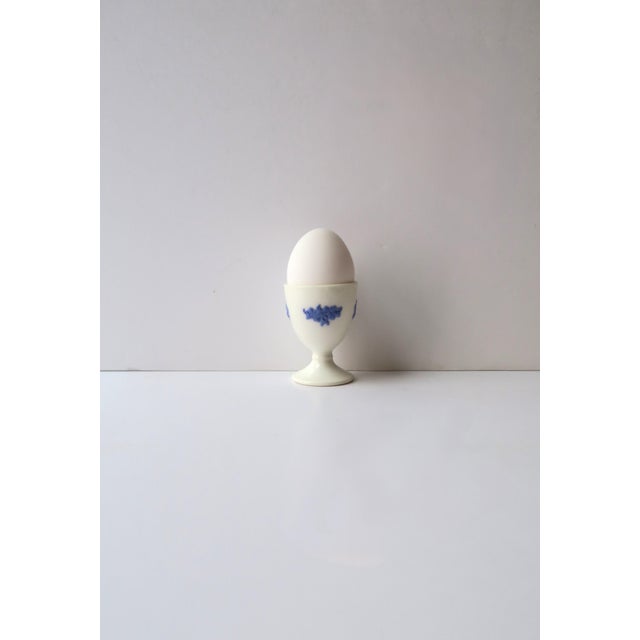 A beautiful blue and white porcelain egg holder cup, circa early-20th century. A predominantly white porcelain egg cup...