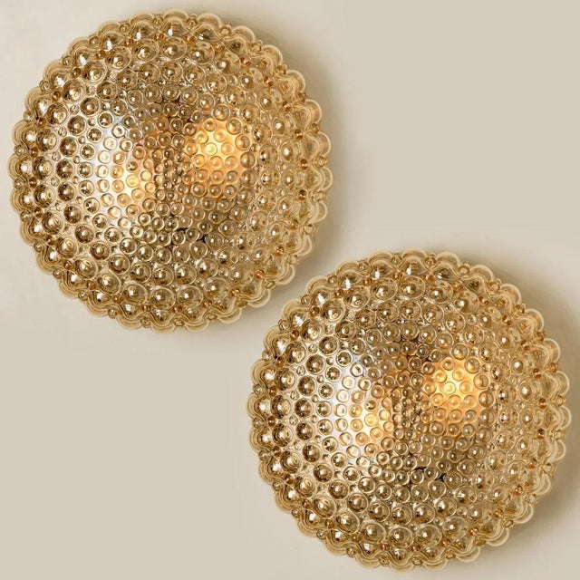 A pair of beautiful bubble glass wall lights designed by helena tynell for glashütte limburg. A design classic, the amber...