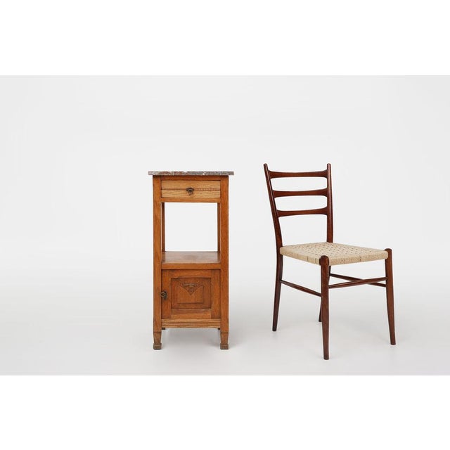 Beautiful crafted French Art Deco nightstand with low cabinet and drawer on high legs from the 1930s. This bedside table...