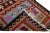 Beautiful vintage Turkish Kilim hand-knotted wool runner with a red field. This rug has a brown frame and multicolor...