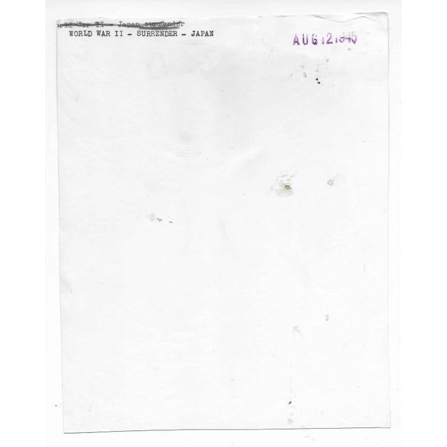 1945 black and white press photograph of soldiers celebrating the end of World War II after the surrender of Japan....